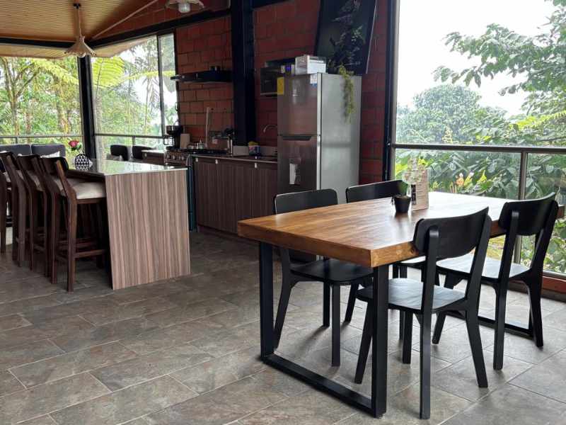 The Guest House at Mashpi Amagusa has a dining table for four with outdoor views.