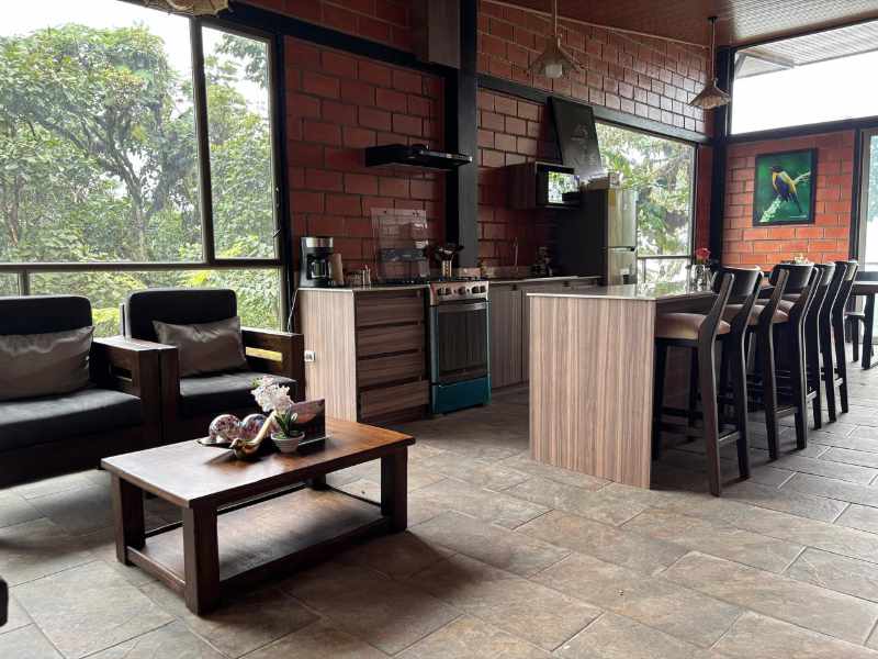 The Guest House at Mashpi Amagusa Lodge includes a living room and an eat-in kitchen with bar.
